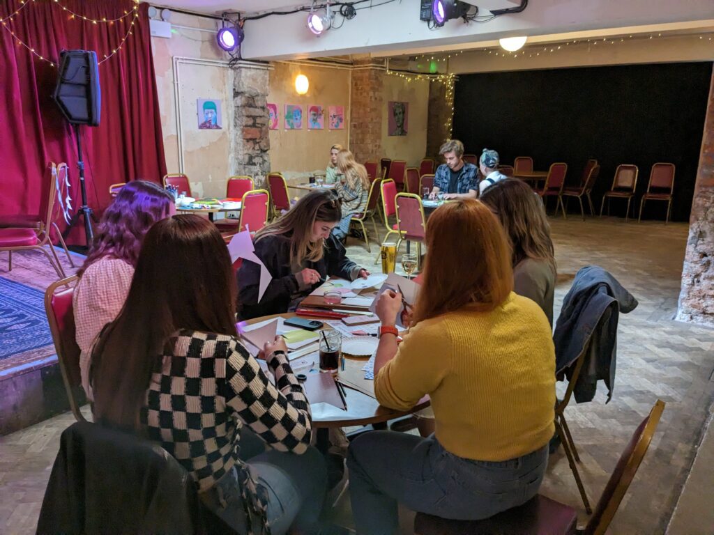 People doing crafts in the Bristol Improv Theatre bar