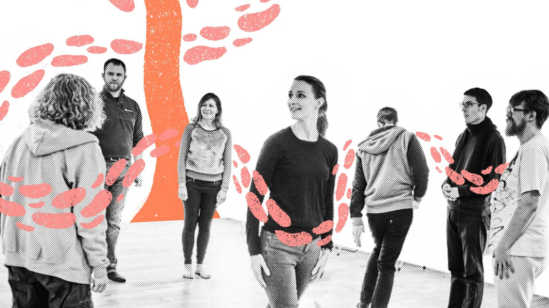 Black and white image. A group of people smiling, with pink & peach illustrated leaves swirling around them.