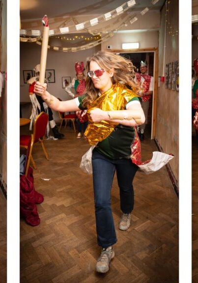 Three people competing in a dress up Christmas game